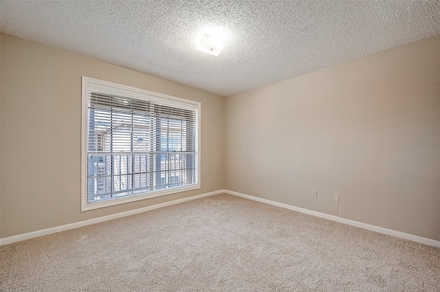 carpeted spare room featuring a textured ceiling