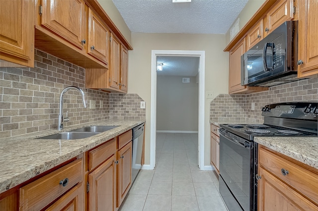 kitchen featuring decorative backsplash, light stone countertops, a textured ceiling, sink, and black appliances