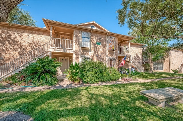 rear view of property with a lawn