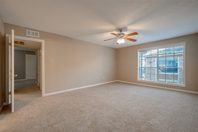 unfurnished room featuring carpet flooring, a textured ceiling, and ceiling fan