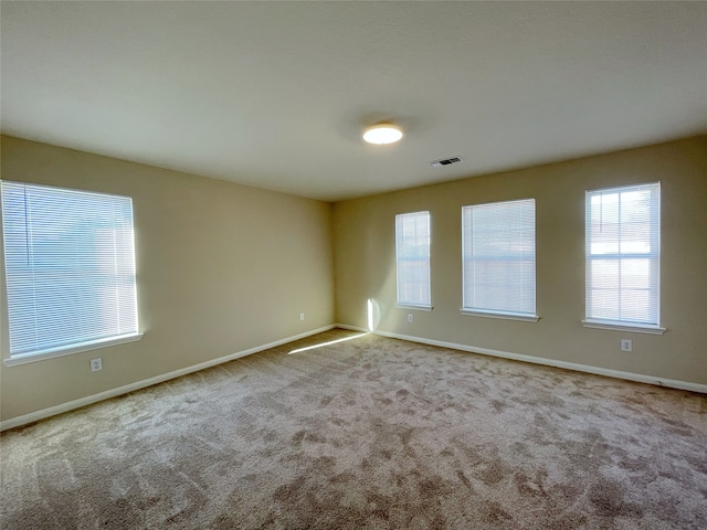 empty room with light colored carpet