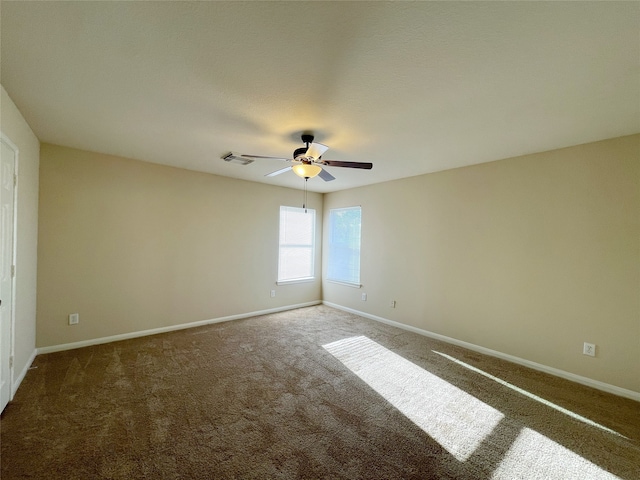 carpeted empty room featuring ceiling fan