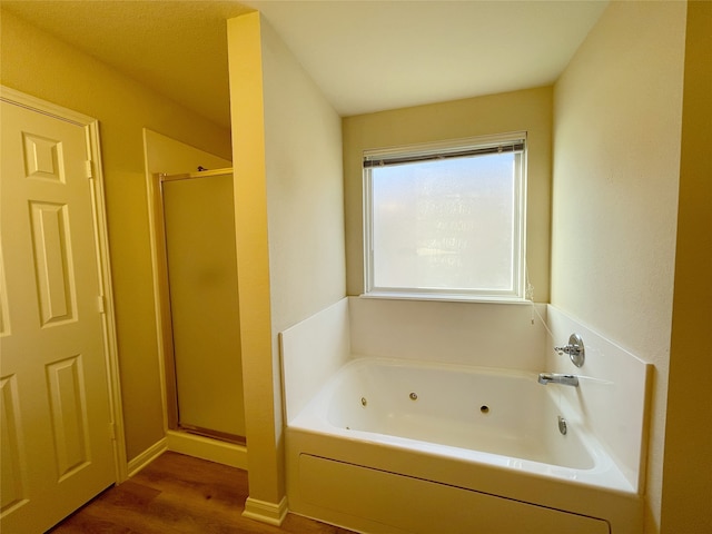 bathroom with plus walk in shower and wood-type flooring