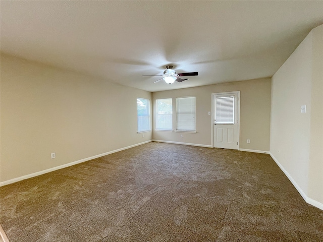 carpeted empty room featuring ceiling fan