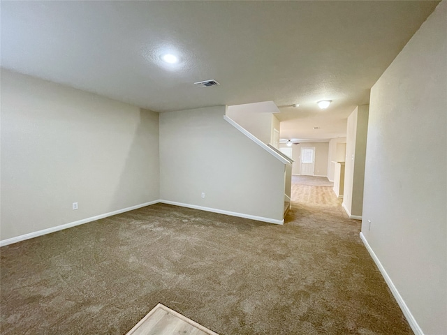 carpeted spare room with a textured ceiling