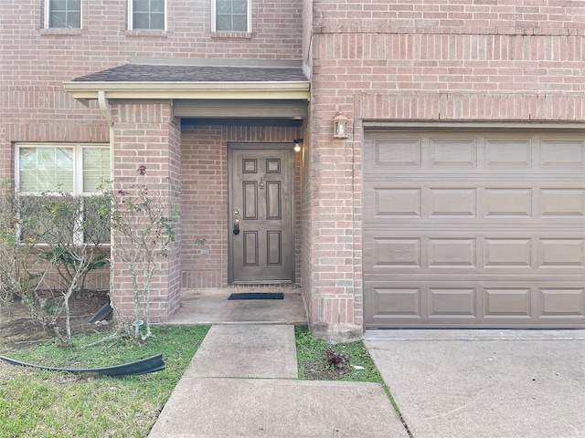 doorway to property with a garage