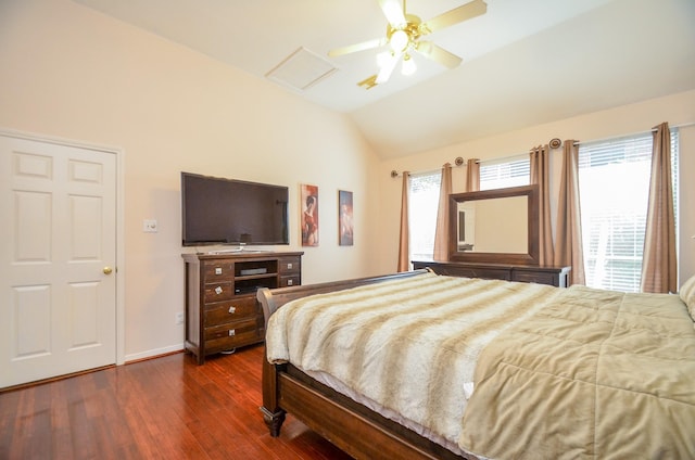 bedroom with multiple windows, ceiling fan, dark wood-type flooring, and vaulted ceiling