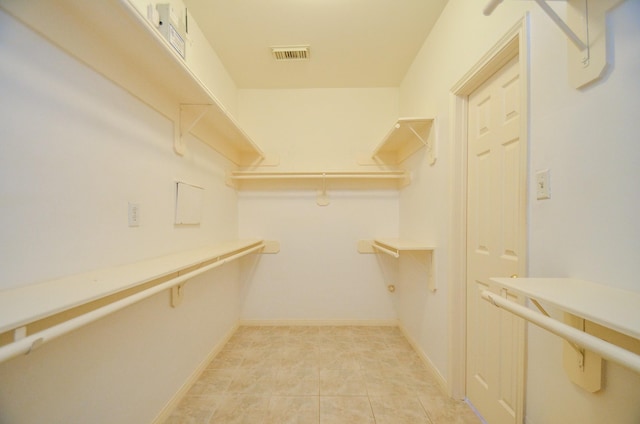 spacious closet featuring light tile patterned floors