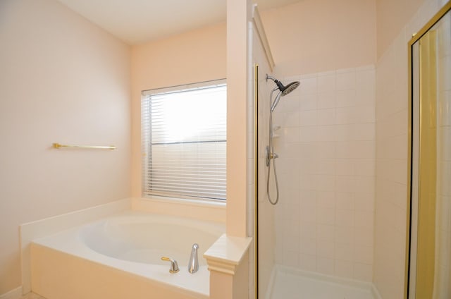 bathroom featuring independent shower and bath