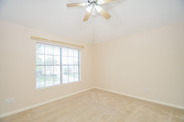 empty room featuring ceiling fan and light colored carpet