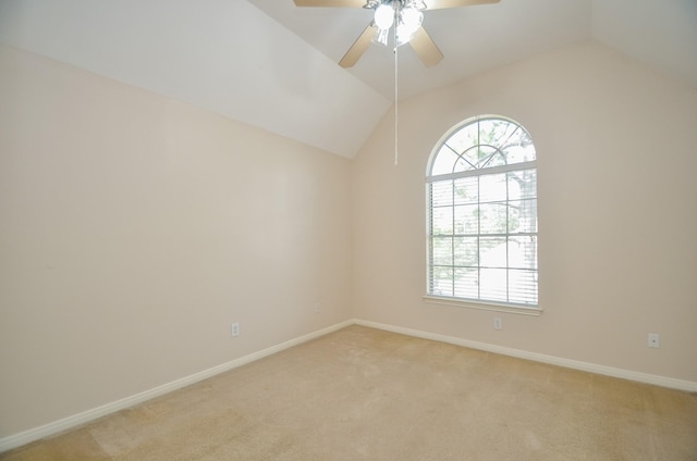 unfurnished room featuring ceiling fan, light carpet, and vaulted ceiling