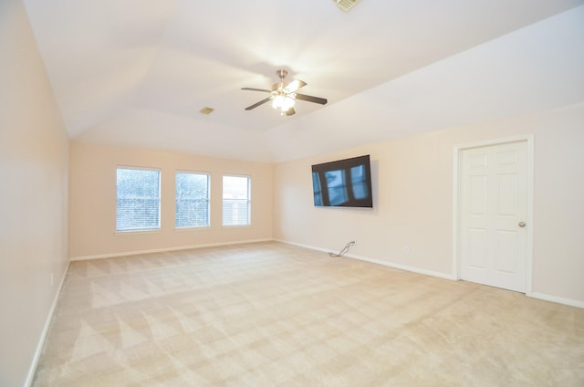 spare room with light carpet, ceiling fan, and lofted ceiling