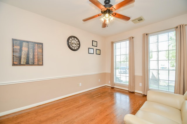 doorway featuring ceiling fan and light hardwood / wood-style floors