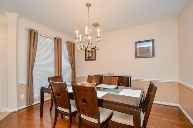 dining room featuring hardwood / wood-style floors and a notable chandelier