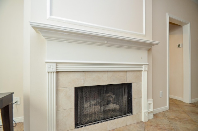 details with a tile fireplace