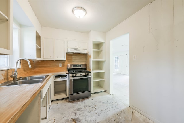 kitchen featuring gas range, sink, white cabinets, and wooden counters