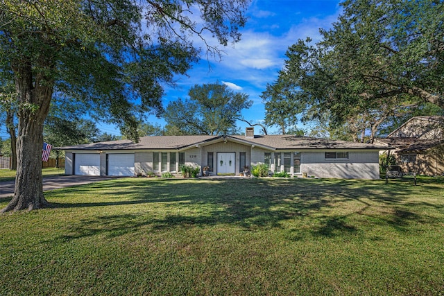 ranch-style home with a front lawn and a garage