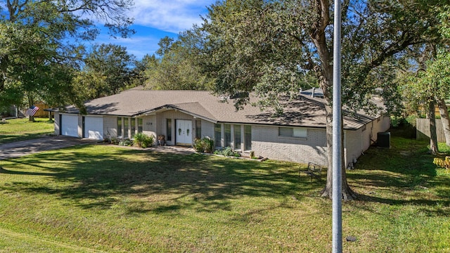 ranch-style house featuring a garage and a front yard