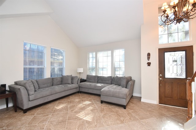 living room with a chandelier, light tile patterned floors, and high vaulted ceiling