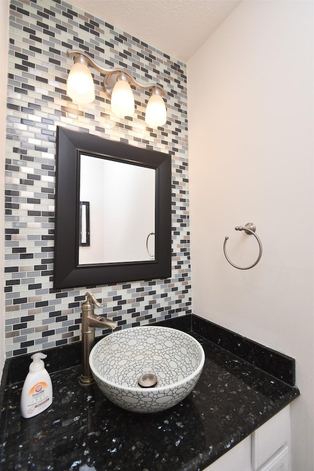 bathroom featuring decorative backsplash and sink