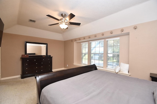 bedroom featuring a tray ceiling, ceiling fan, and carpet