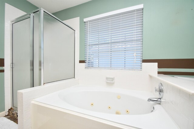 bathroom featuring separate shower and tub