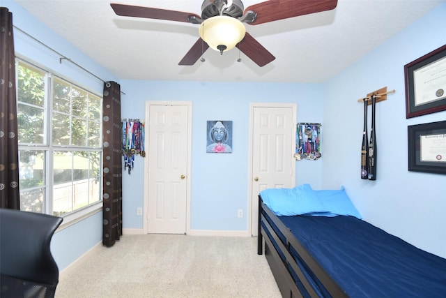 carpeted bedroom with ceiling fan