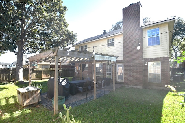 rear view of property featuring a pergola, a yard, and a patio