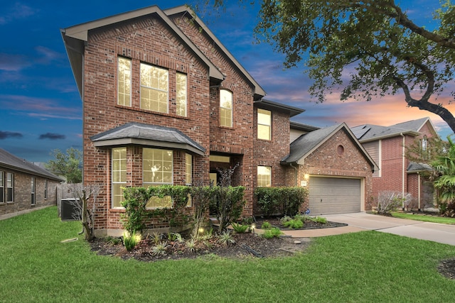 front of property with a lawn and a garage