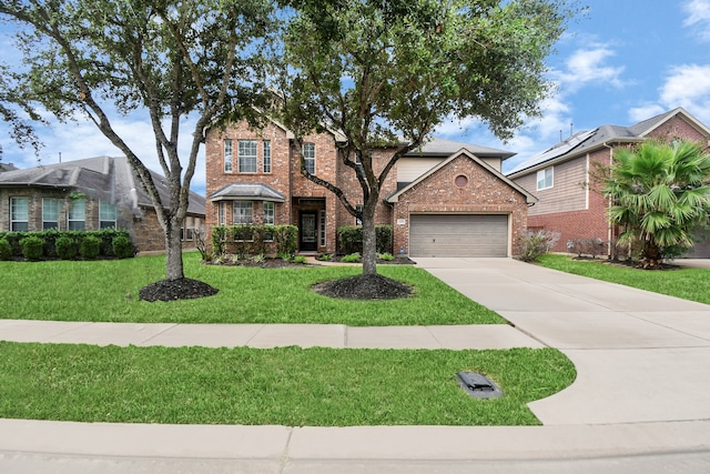 view of front of property with a front lawn and a garage