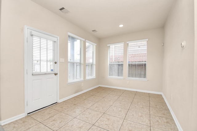 entryway with light tile patterned floors