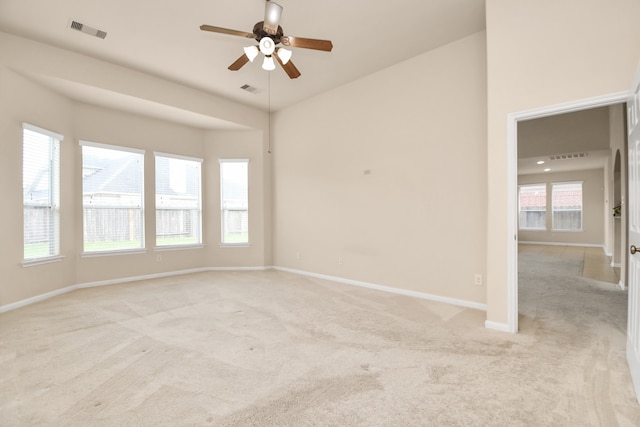 unfurnished room featuring light carpet and ceiling fan