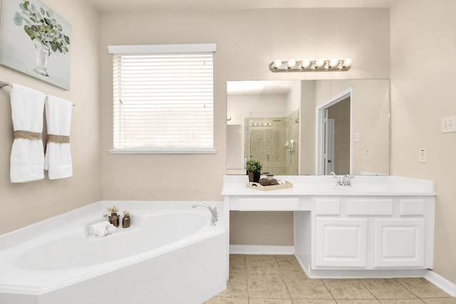 bathroom featuring tile patterned flooring, vanity, and separate shower and tub