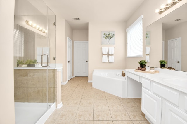 bathroom featuring tile patterned flooring, vanity, and separate shower and tub