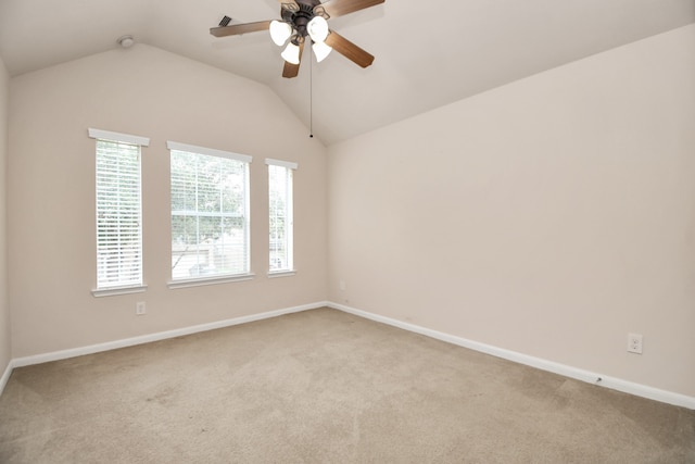 carpeted empty room featuring ceiling fan, a healthy amount of sunlight, and vaulted ceiling