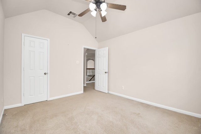 unfurnished bedroom with ceiling fan, light carpet, and vaulted ceiling