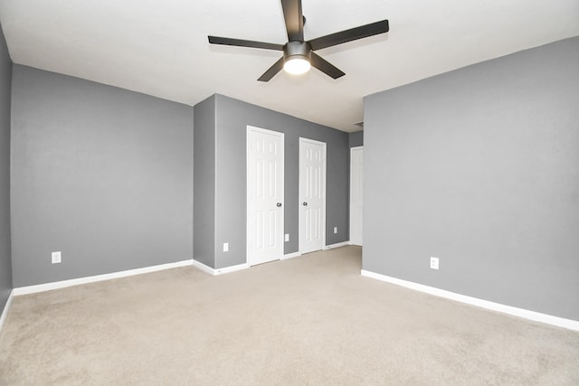 carpeted empty room with ceiling fan