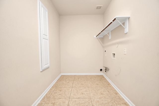 laundry room featuring electric dryer hookup, gas dryer hookup, hookup for a washing machine, and light tile patterned floors