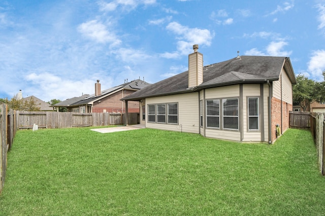 back of house featuring a patio area and a yard