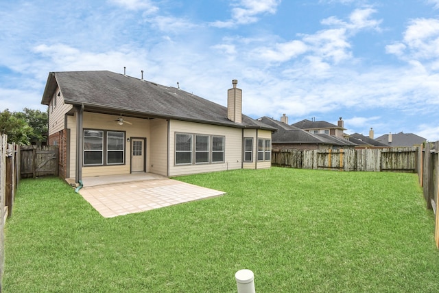 back of house featuring a yard, ceiling fan, and a patio area