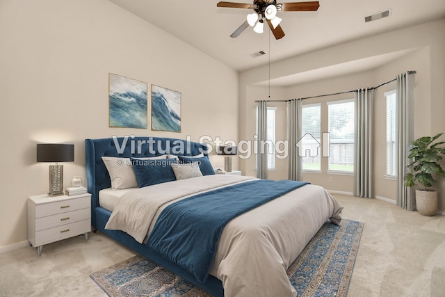 carpeted bedroom with ceiling fan and vaulted ceiling