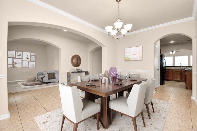 dining room with crown molding, sink, light tile patterned floors, and an inviting chandelier