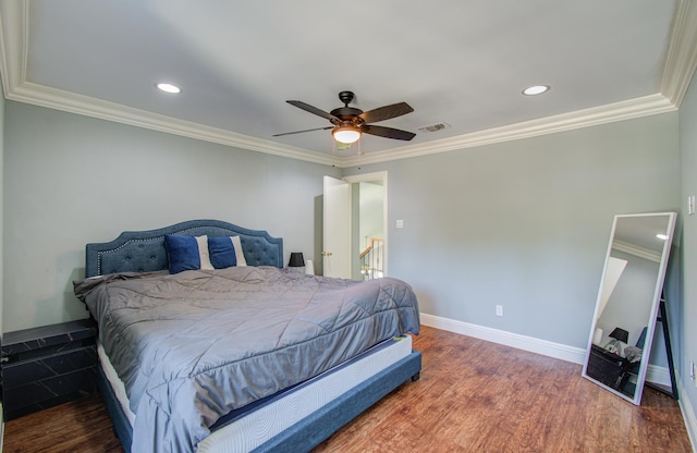 bedroom featuring ceiling fan, dark hardwood / wood-style flooring, and ornamental molding