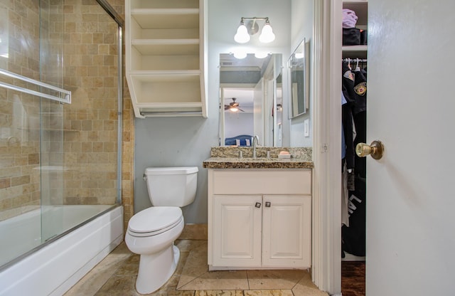 full bathroom featuring tile patterned floors, toilet, vanity, and combined bath / shower with glass door