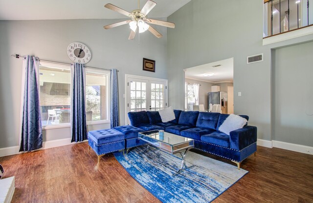 living room with high vaulted ceiling, ceiling fan, and dark wood-type flooring