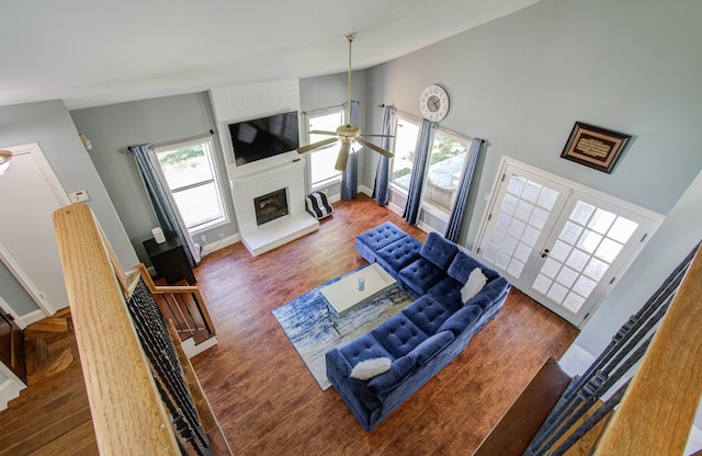 living room featuring a wealth of natural light, high vaulted ceiling, and dark hardwood / wood-style floors