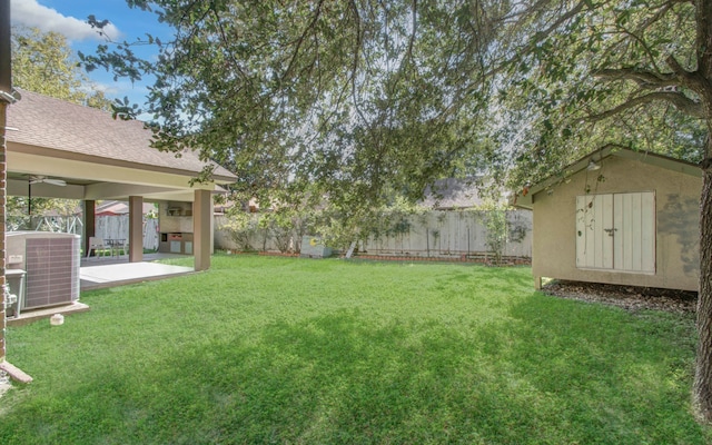 view of yard featuring central AC and a patio area