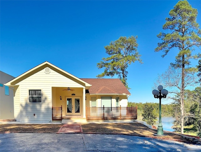 113 Cottonwood Rd, Trinity, TX 75862 - view of front of home with french doors, a ceiling fan, a shingled roof, and covered porch