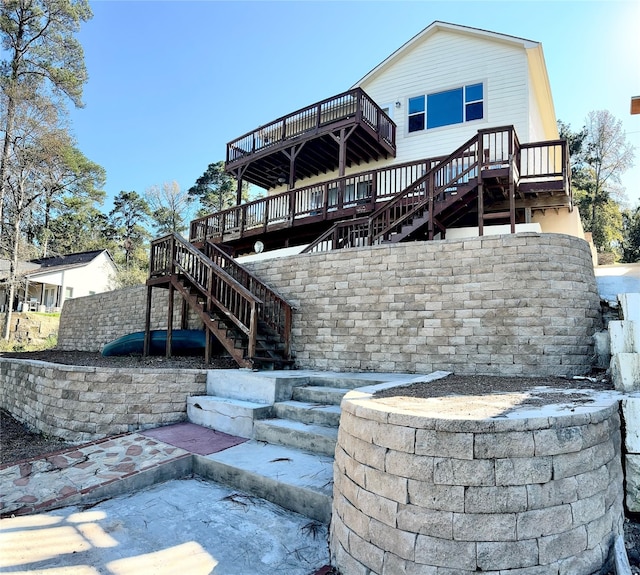 rear view of property featuring a wooden deck