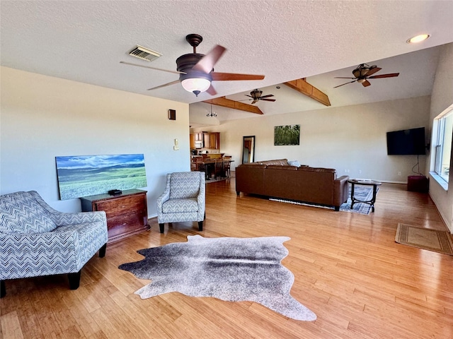 113 Cottonwood Rd, Trinity, TX 75862 - living room featuring ceiling fan, wood finished floors, a textured ceiling, and lofted ceiling